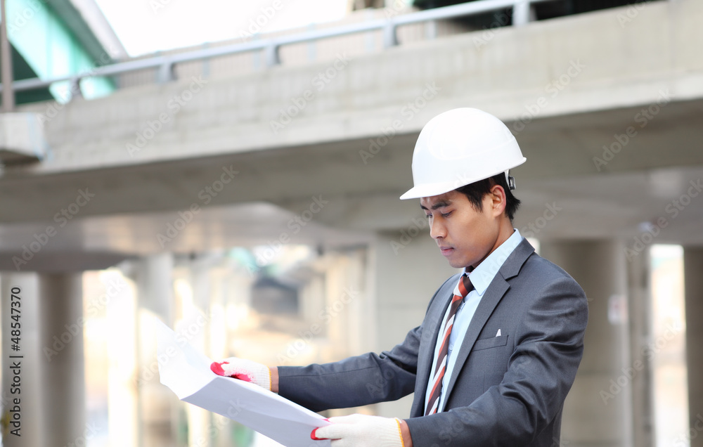 architect checking a drawing with highway construction architect checking a drawing with highway construction