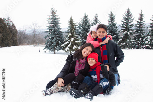 East Indian family playing in the snow