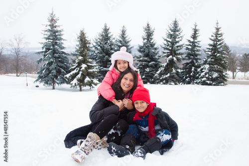 East Indian family playing in the snow