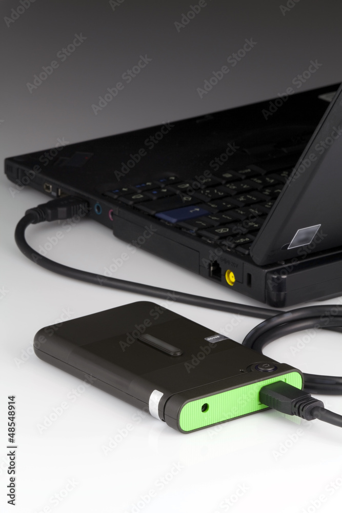 The external hard drive connected to the laptop The external hard drive connected to the laptop