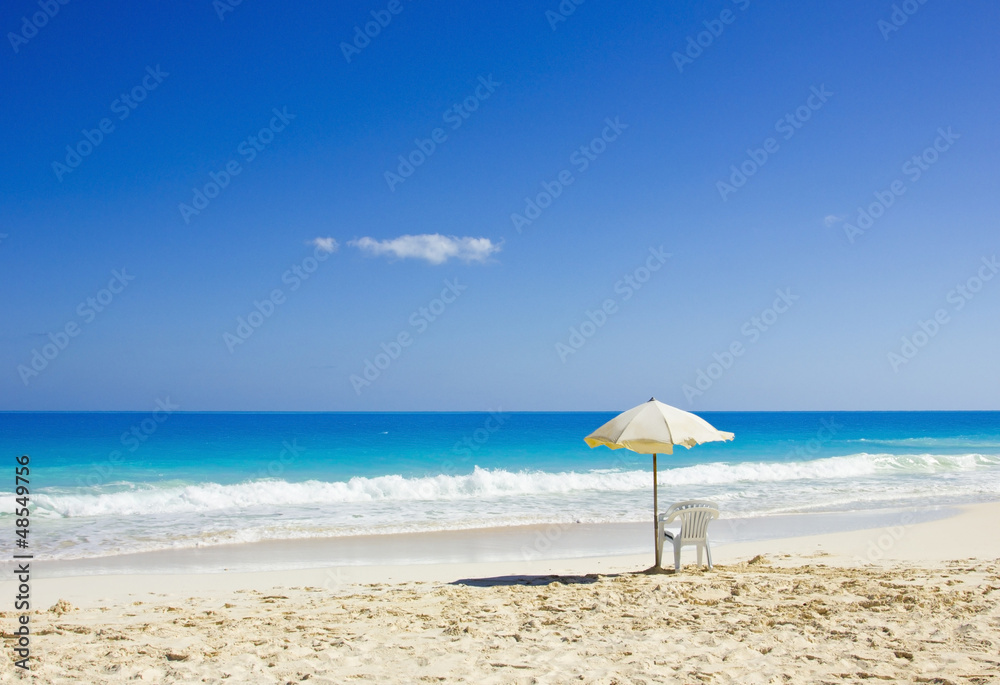 BEACH CHAIR AND UMBRELLA ON IDYLLIC TROPICAL SAND BEACH CHAIR AND UMBRELLA ON IDYLLIC TROPICAL SAND