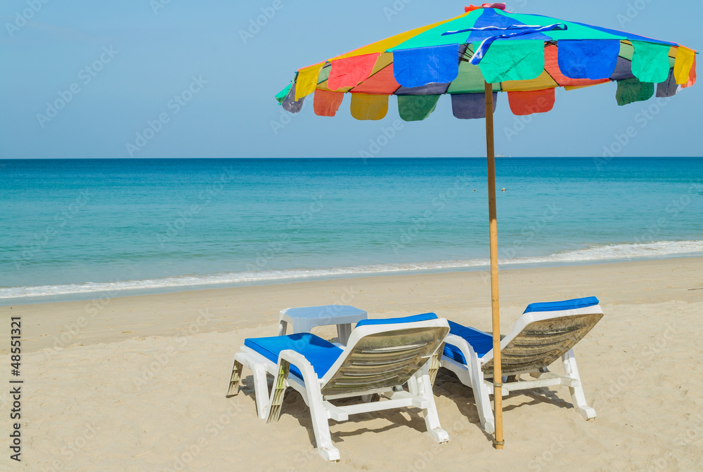 colourful beach umbrella and deck chairs on the beach