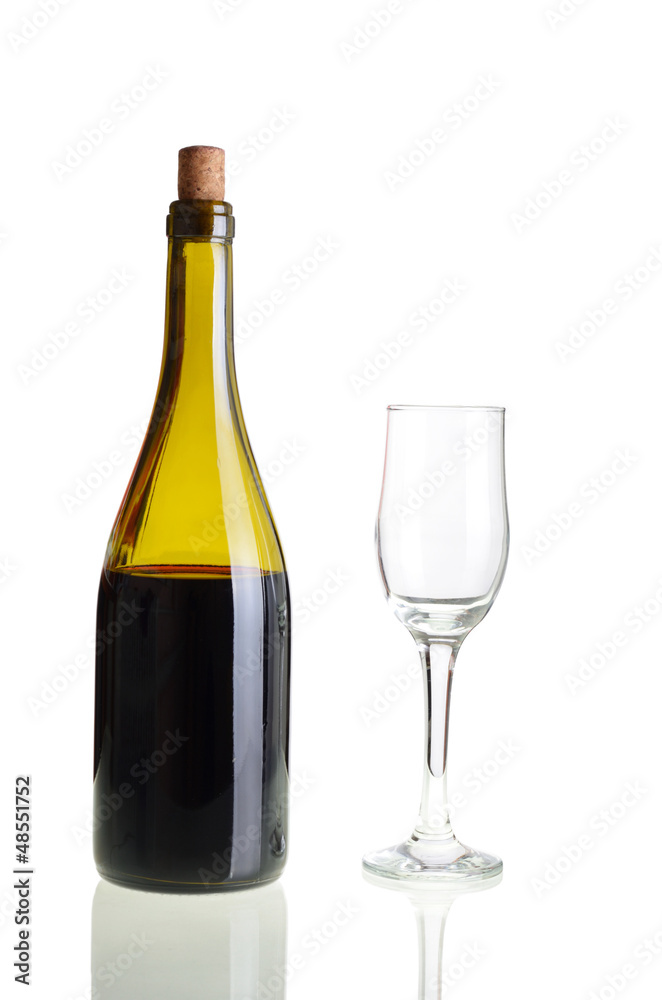 Red wine bottle with empty glass