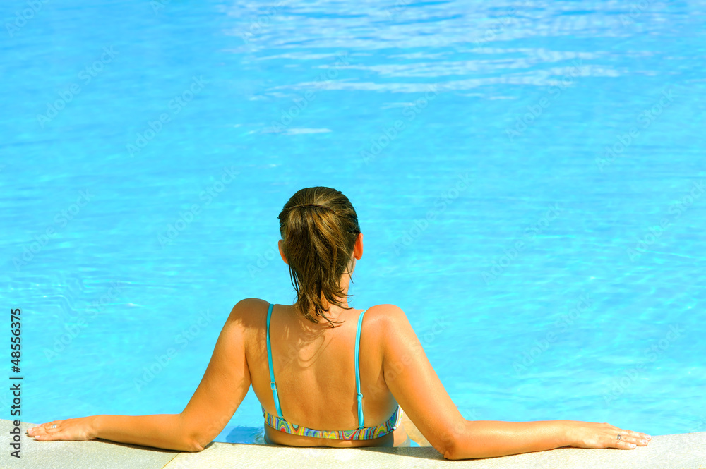 Female beauty posing in the swimming pool