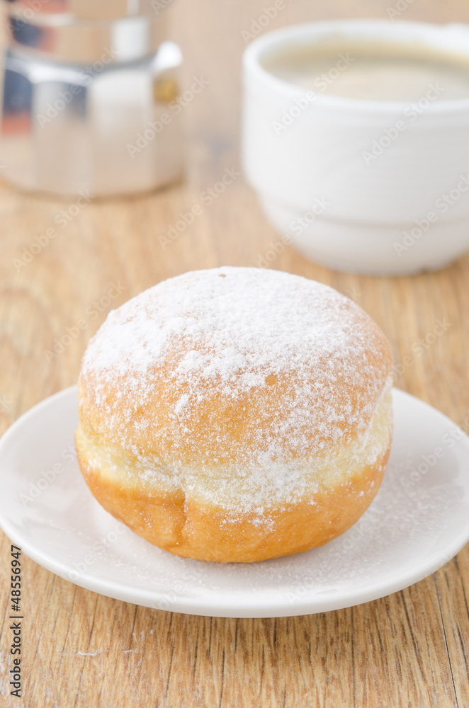 sweet donut on a plate and cup of coffee