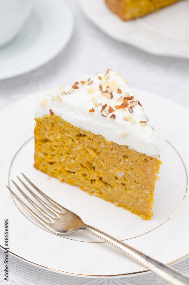 piece of pumpkin cake with cream closeup