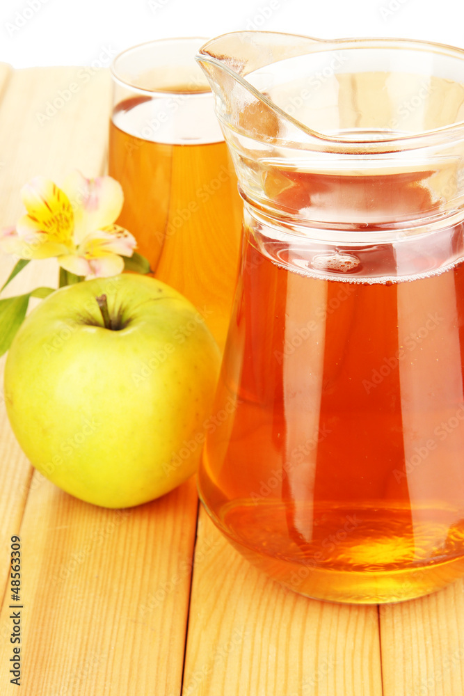 Full glass and jug of apple juice and apples on wooden table Full glass and jug of apple juice and apples on wooden table