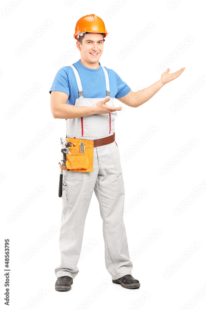Full length portrait of a manual worker with tool belt and helme Full length portrait of a manual worker with tool belt and helme