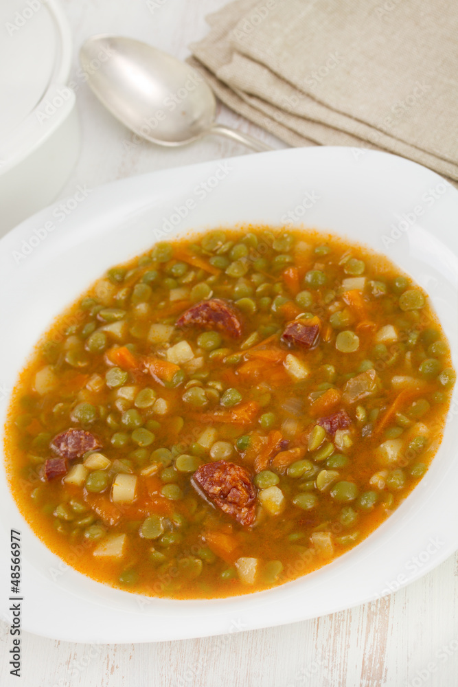 soup with peas and sausages in white plate soup with peas and sausages in white plate