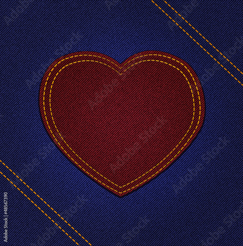 Red jeans heart on blue denim background
