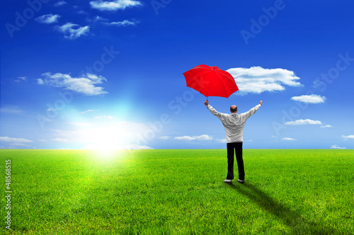 Happy man with red umbrella jubilates - enjoying life photo