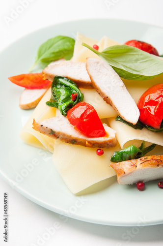 Pasta with chicken, spinach, cherry tomatoes and fresh herbs