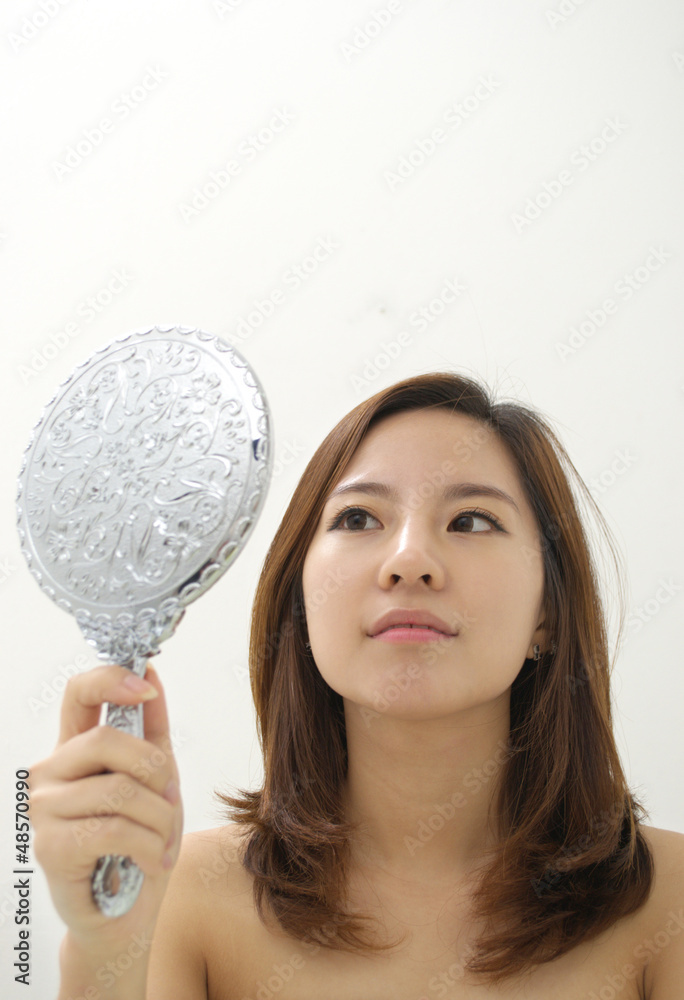 Woman looking at her reflection Woman looking at her reflection
