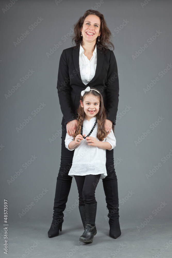 Happy mother with young daughter. Studio shot.