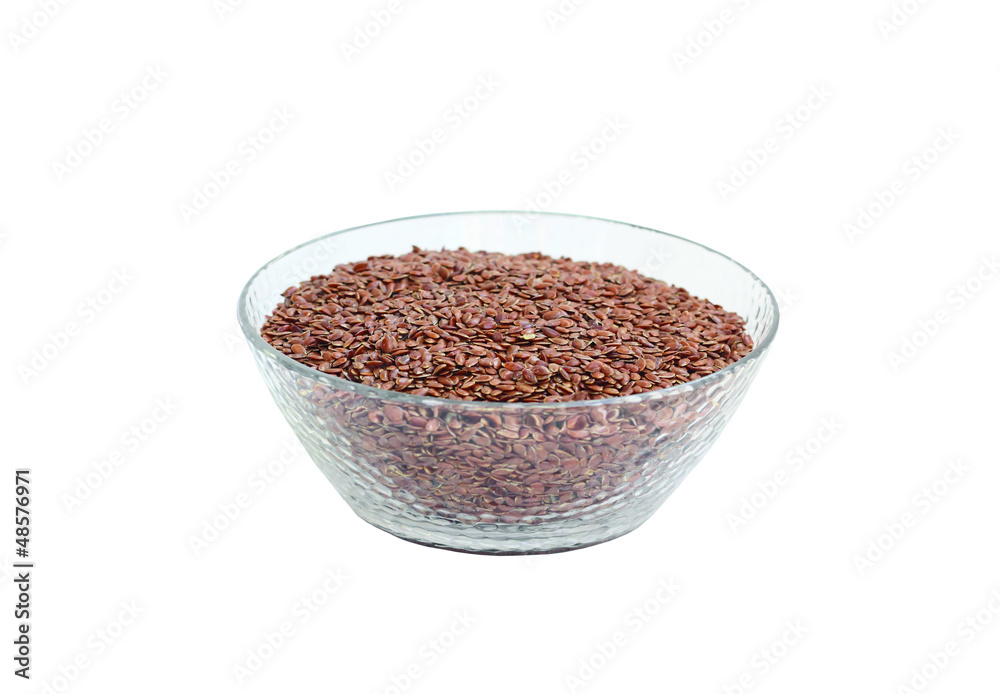 Flax seeds in glasswares. It is isolated on the white.