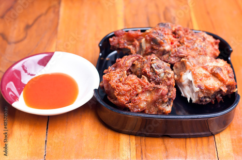 Fried chicken with sauce on wood table