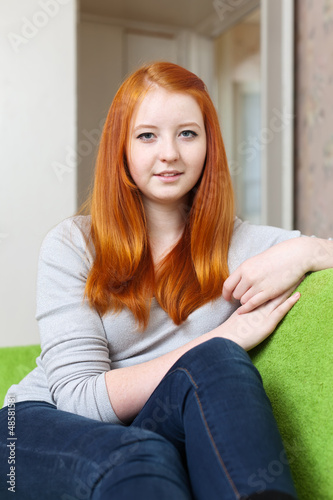  red-haired tenager girl in home interior photo