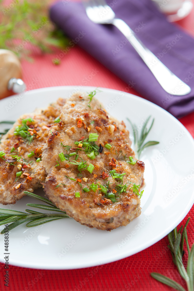 two pieces of fried meat, sprinkle with greens two pieces of fried meat, sprinkle with greens