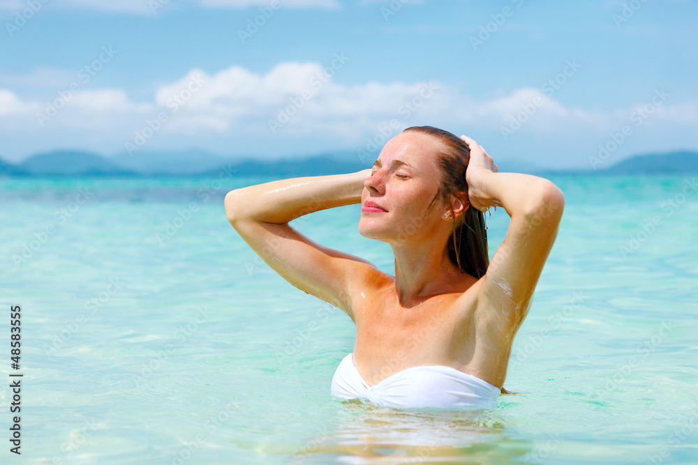Beautiful young woman enjoying swimming in refreshing sea water Beautiful young woman enjoying swimming in refreshing sea water