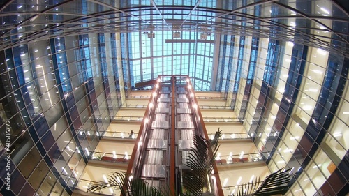 Two elevators go to business-center where light in windows of photo