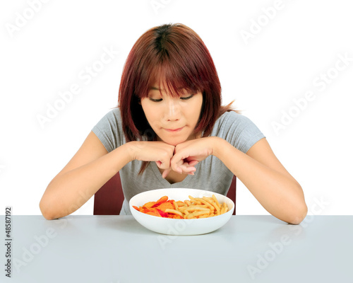 Isolated young asian woman with a plate of potato chips and fren