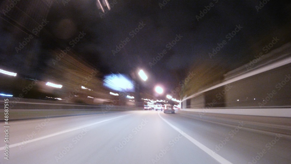 Clouds are visible in evening above flow of cars which goes Clouds are visible in evening above flow of cars which goes