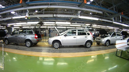 Workers do car complete set in assembly shop photo
