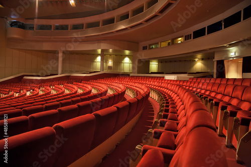 red armchairs rows in auditorium photo