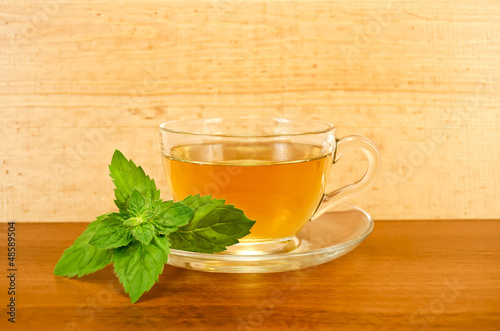 Herbal tea with mint on a wooden board