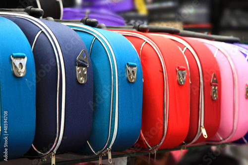 Colorful suitcases in a row on the rack