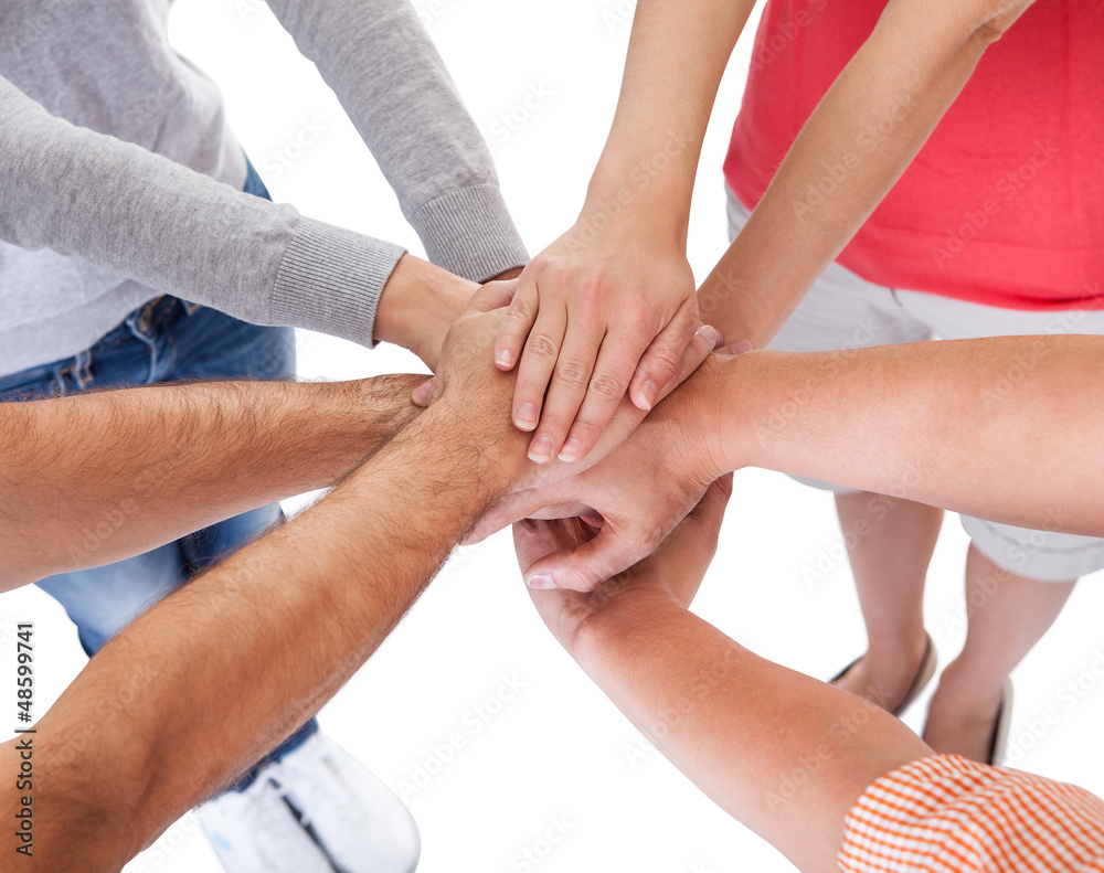 Four casual middle-aged friends holding hands Four casual middle-aged friends holding hands