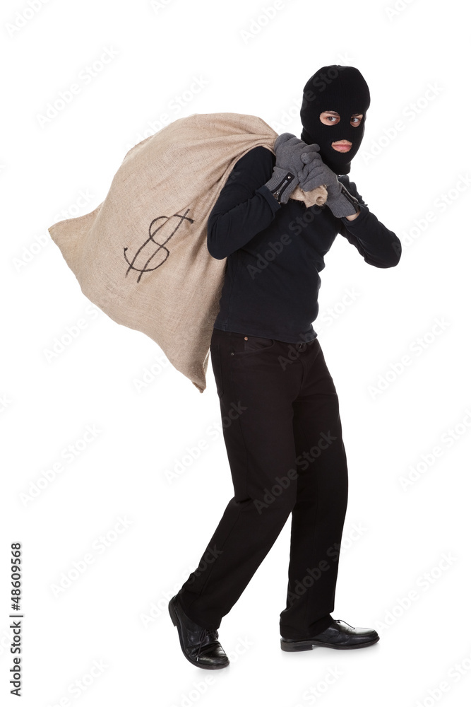 Thief carrying a large bag of money