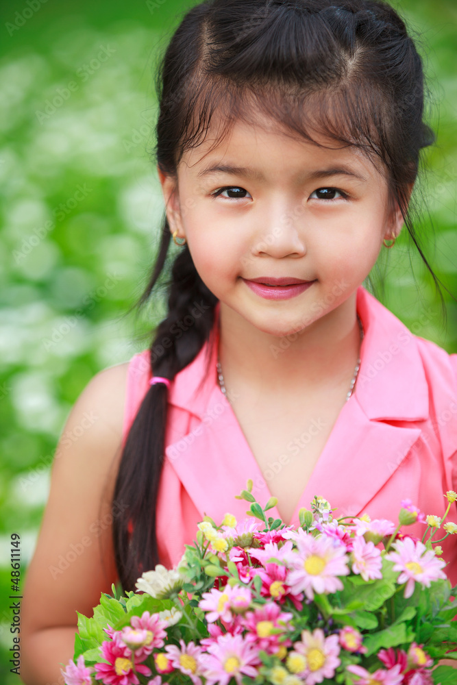 Asian little girl with flower in field of flowers Asian little girl with flower in field of flowers
