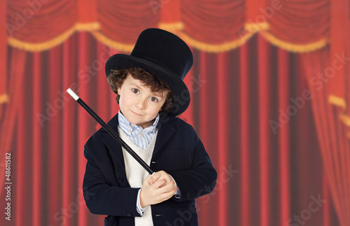 фотографія Adorable child dress of illusionist with hat