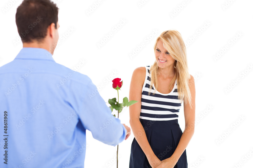 young man giving rose to a beautiful young woman young man giving rose to a beautiful young woman