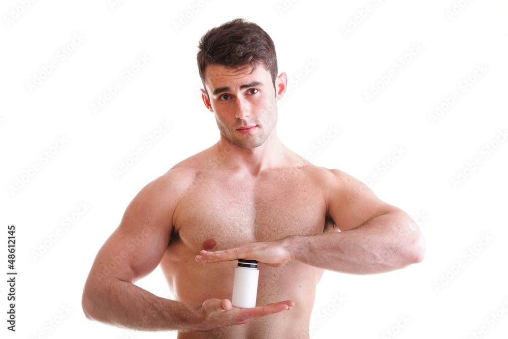 sexy male body builder holding a boxes with supplements on his b