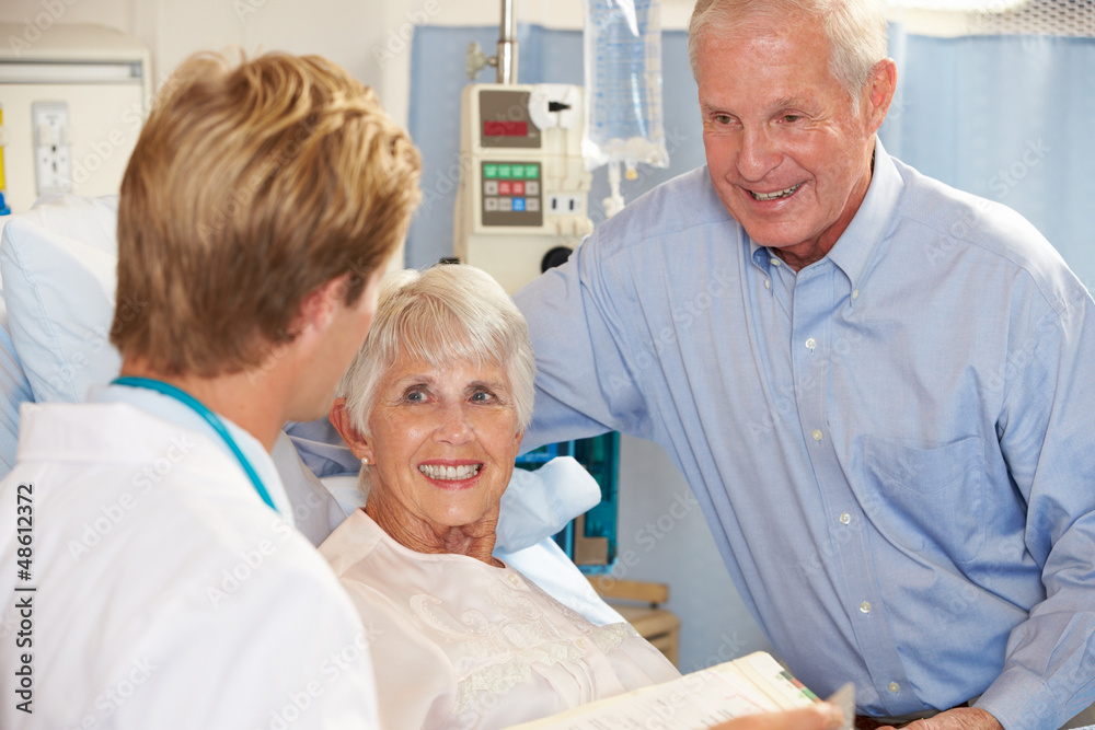 Doctor Talking To Senior Couple On Ward Doctor Talking To Senior Couple On Ward