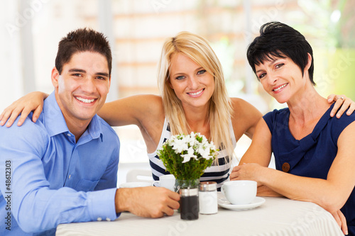 Tapeta happy young man with wife and mother-in-law in cafe