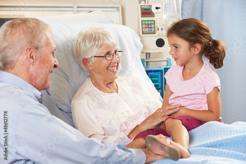 Granddaughter Visiting Grandmother In Hospital Bed