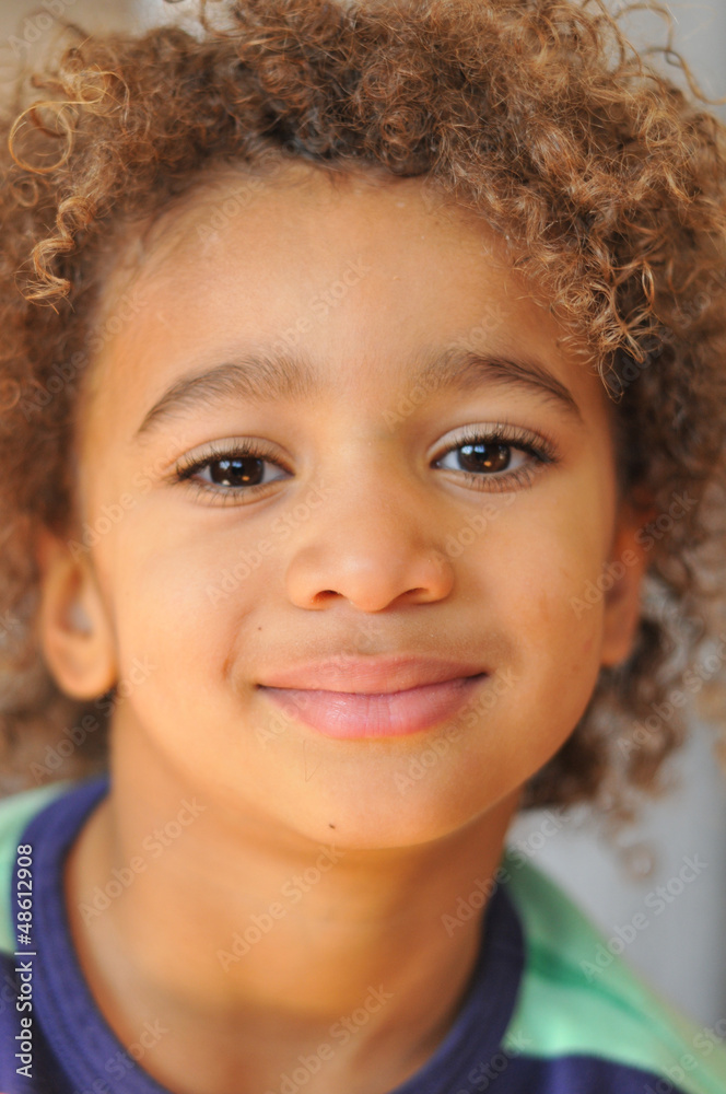 Young mixed race boy with curly hair