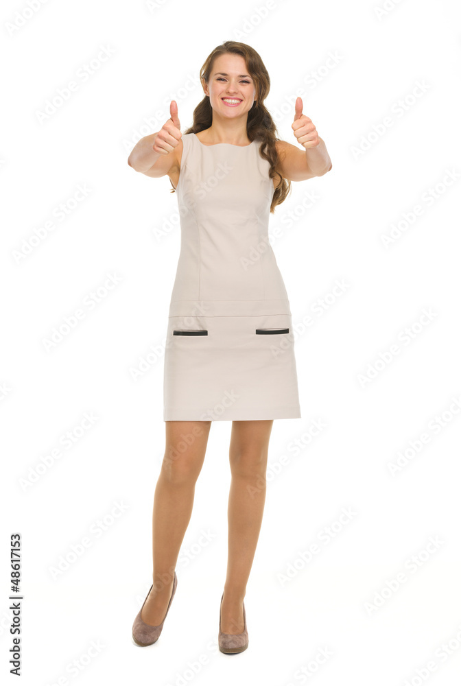 Full length portrait of happy young woman showing thumbs up Full length portrait of happy young woman showing thumbs up