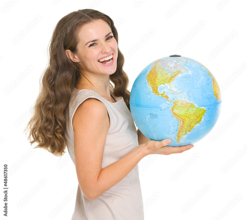 Smiling young woman holding globe Smiling young woman holding globe