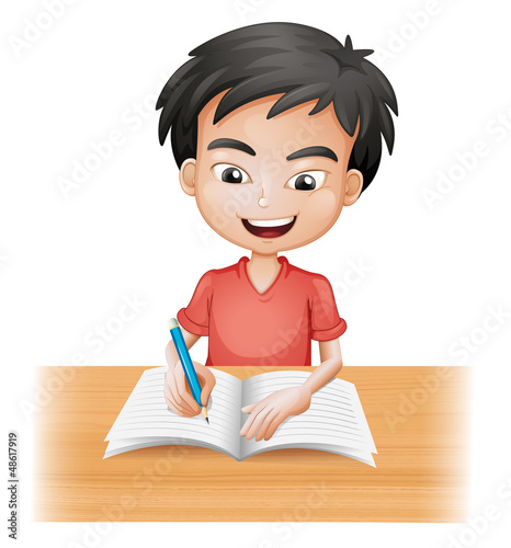 A smiling boy writing