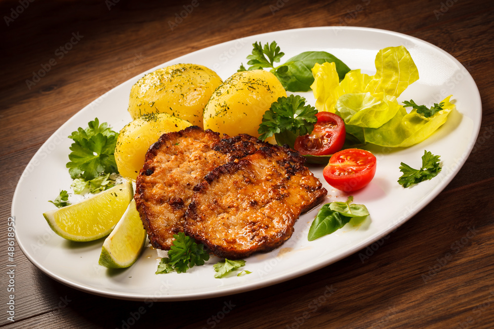 Grilled steaks, boiled potatoes and vegetables Grilled steaks, boiled potatoes and vegetables