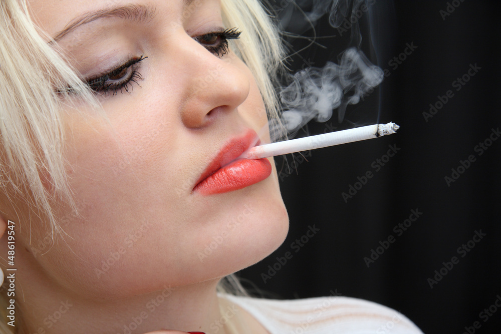 Fototapeta premium young girl smokes cigarette.