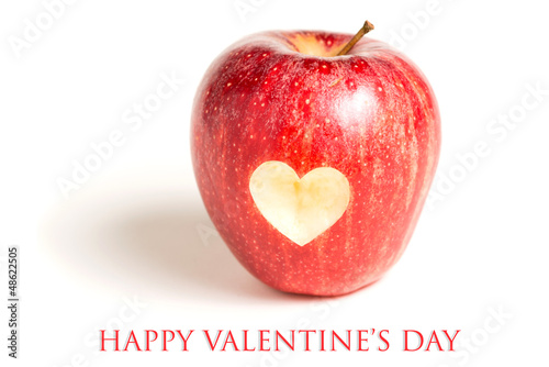 Red apple with heart on white background