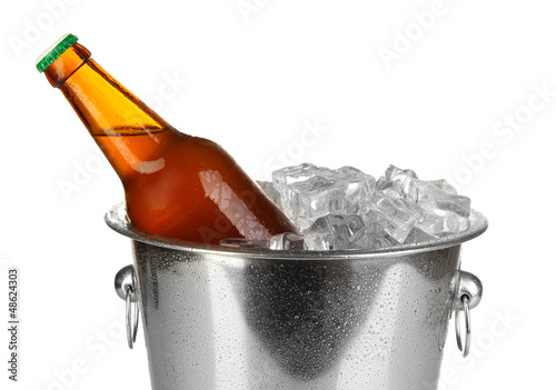 Beer bottle in ice bucket isolated on white photo
