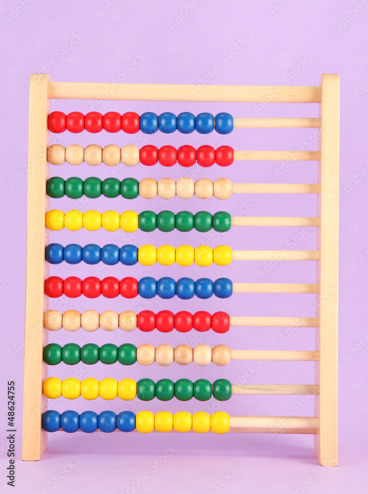 Bright wooden toy abacus, on purple background Bright wooden toy abacus, on purple background