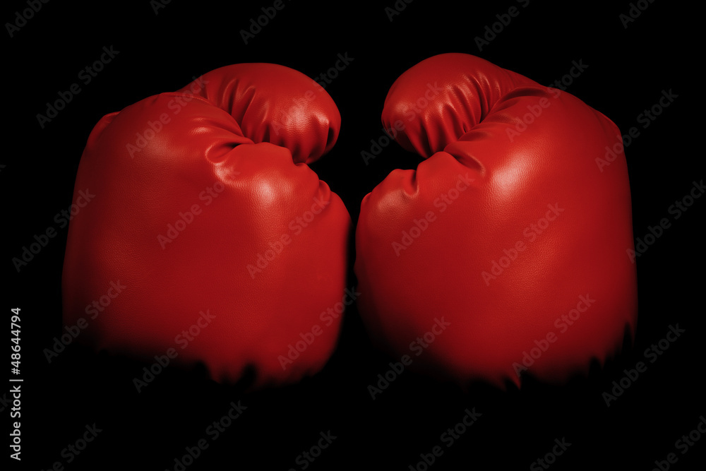 Vintage boxing gloves emerging from black background