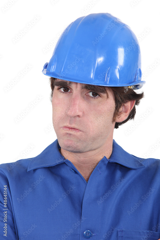 head-and-shoulders portrait of craftsman looking exasperated head-and-shoulders portrait of craftsman looking exasperated